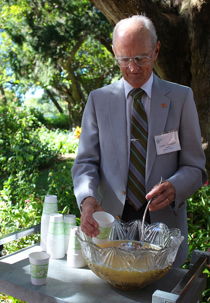 Larry Steagall serves attendees punch.