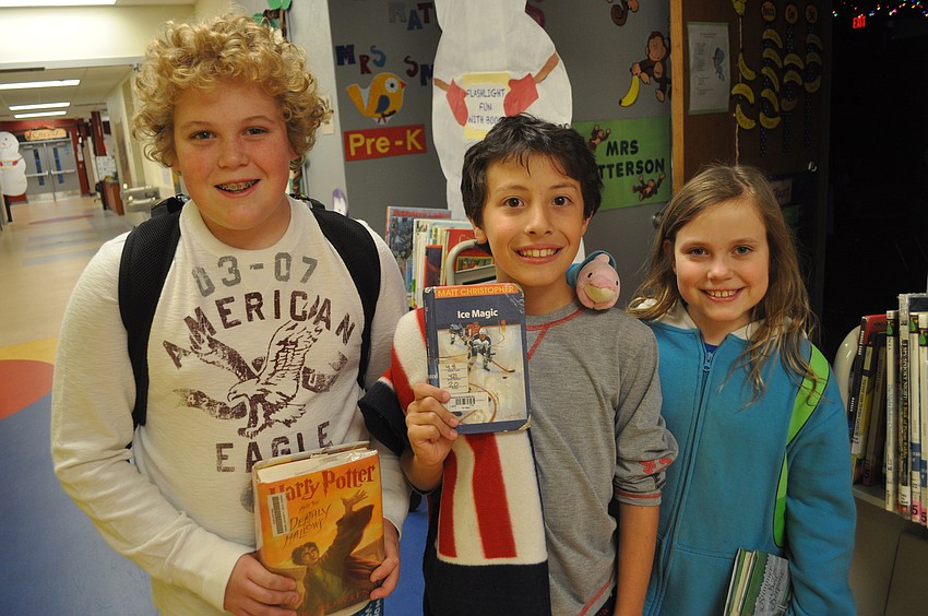 Sixth-grader Tommy Suba and fourth-graders Frankie Petrone and Heidi Suba showed off their favorite books.
