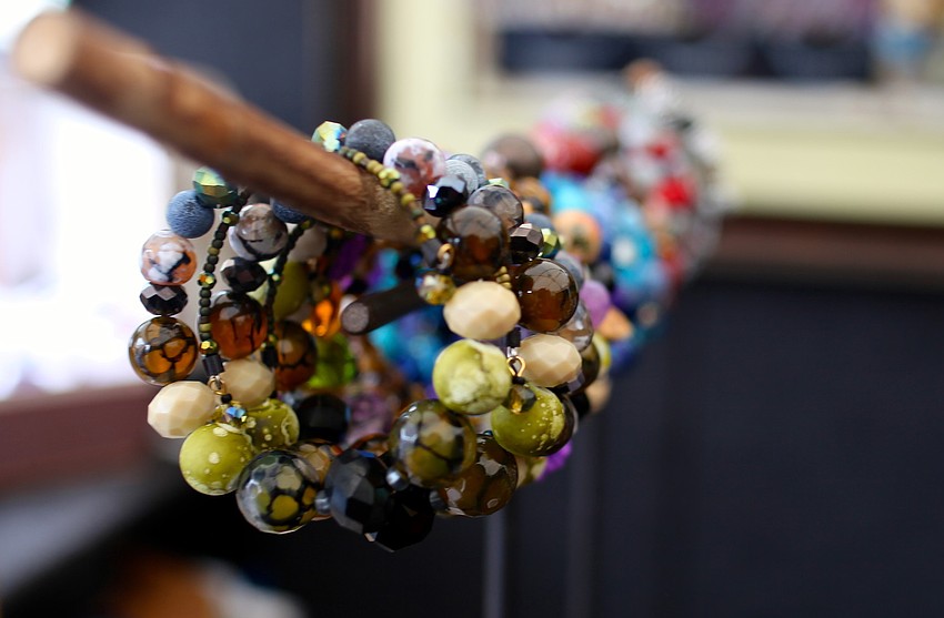 Bracelets made of handmade beads are featured at the booth of Blue Palms Fiber Art.