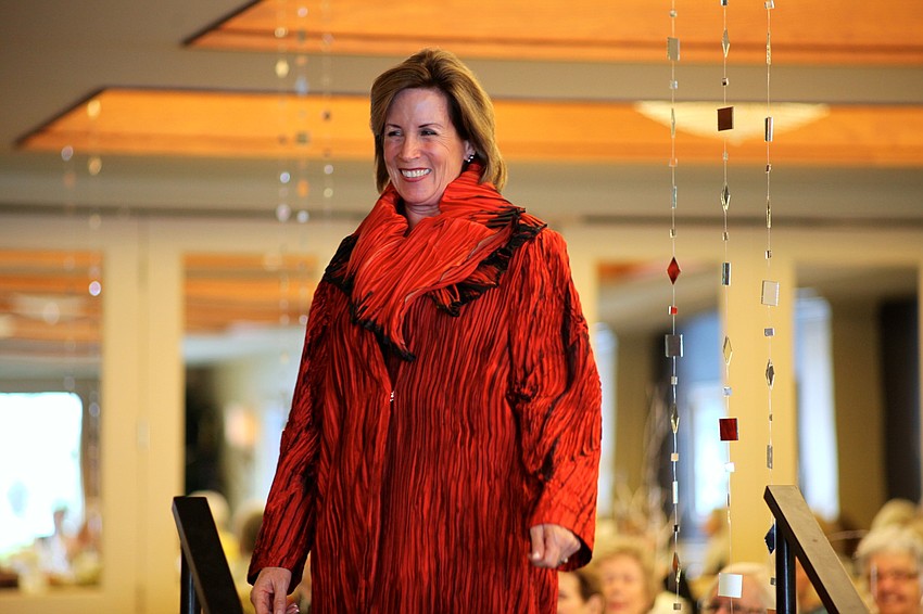 Medora Frye wears a red shibori fused coat and matching scarf.