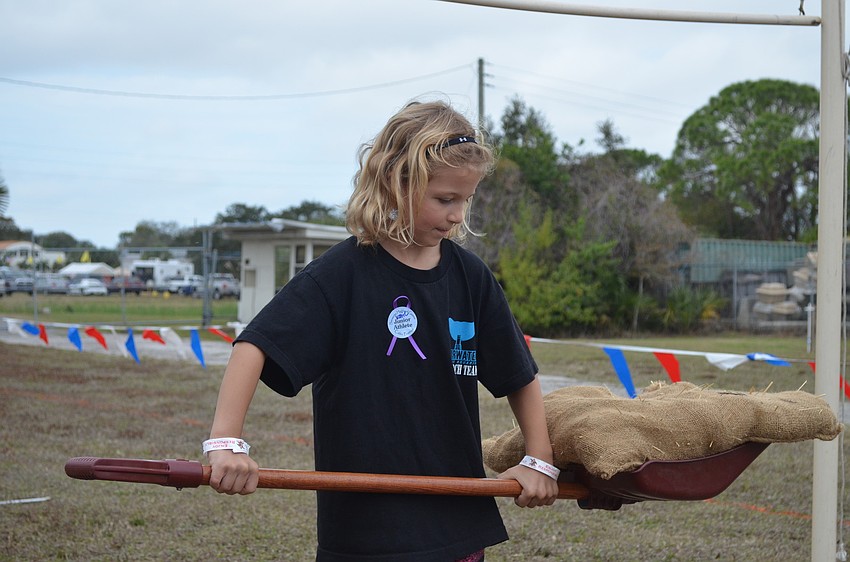 Kaitlyn Deinlein tries her her hand at a miniature sheaf toss.