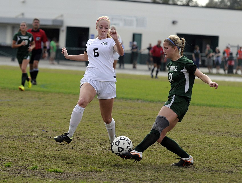Lakewood Ranch senior Delaney Riggins battles a Seminole defender for the ball during the first half.