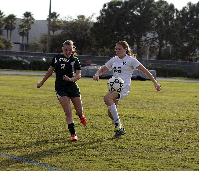 Lakewood Ranch midfielder Carly Mitchell attempts to maintain possession for the Lady Mustangs late in the second half.