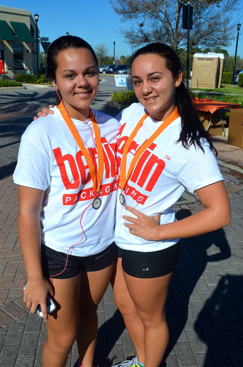 Tortolano sisters, Maris, 17, and Bianca, 16, take a break after the race.