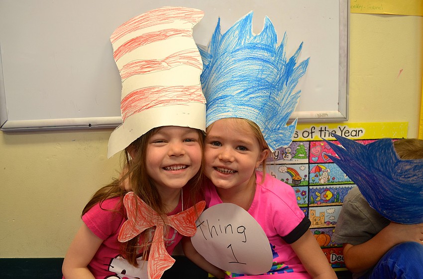 Four-year-olds Zoe Coppock and Elise Kudelko wear hats inspired by Dr. Seuss' characters.