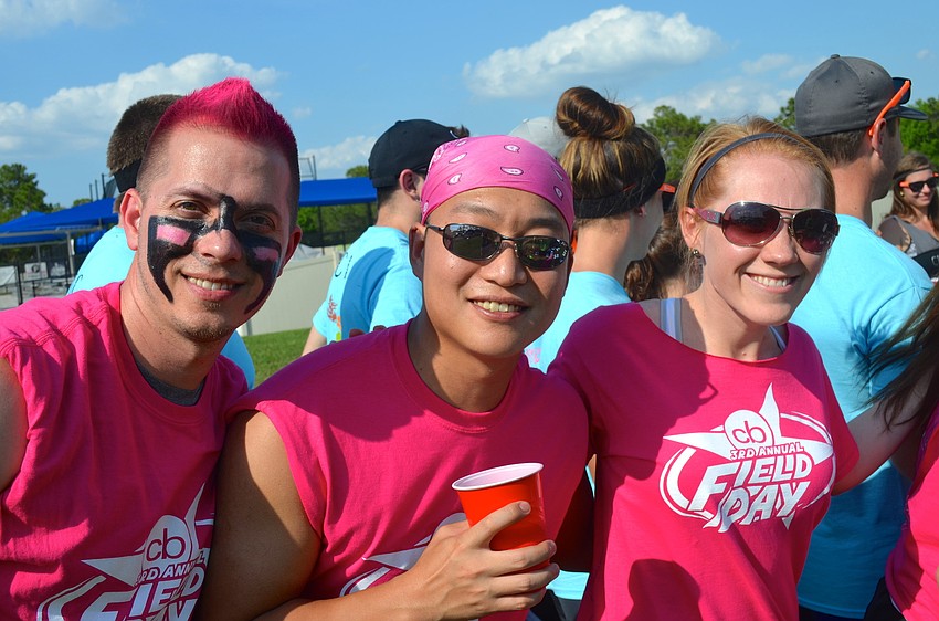 Brian Vaughn, Jesse Price and Stefanie Brady show their pink team pride.