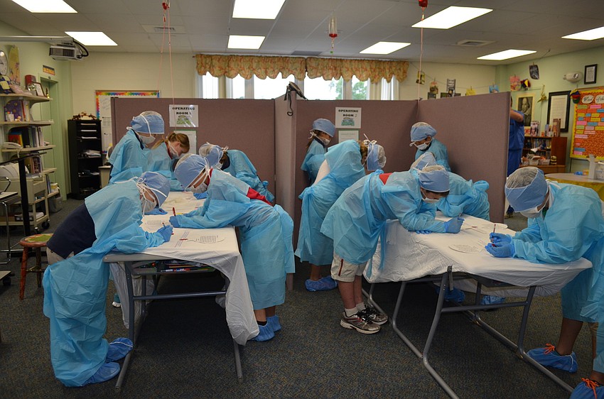 The classroom was divided into four operating tables.