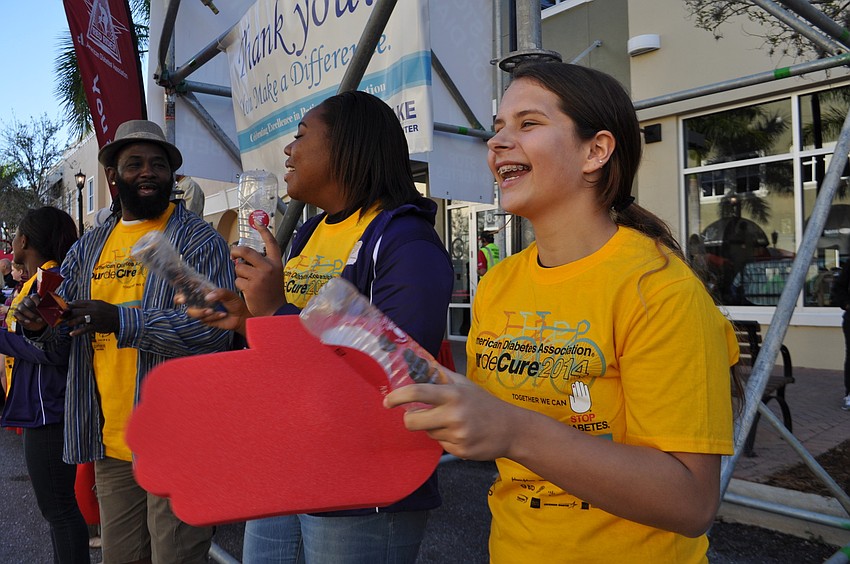 Tabatha Townsend, right, cheers on riders as they start their route.