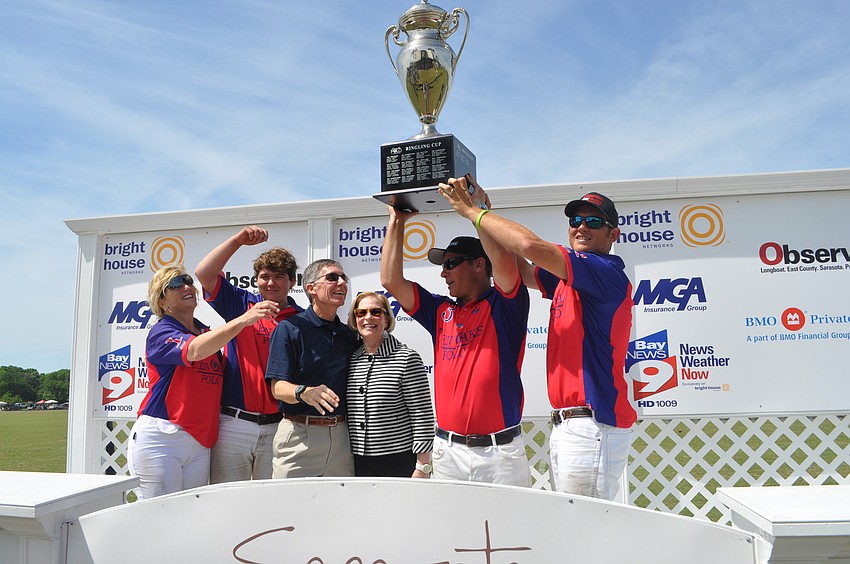 Ten Oaks Polo celebrates its win with Matt and Lisa Walsh of the Observer Media Group.