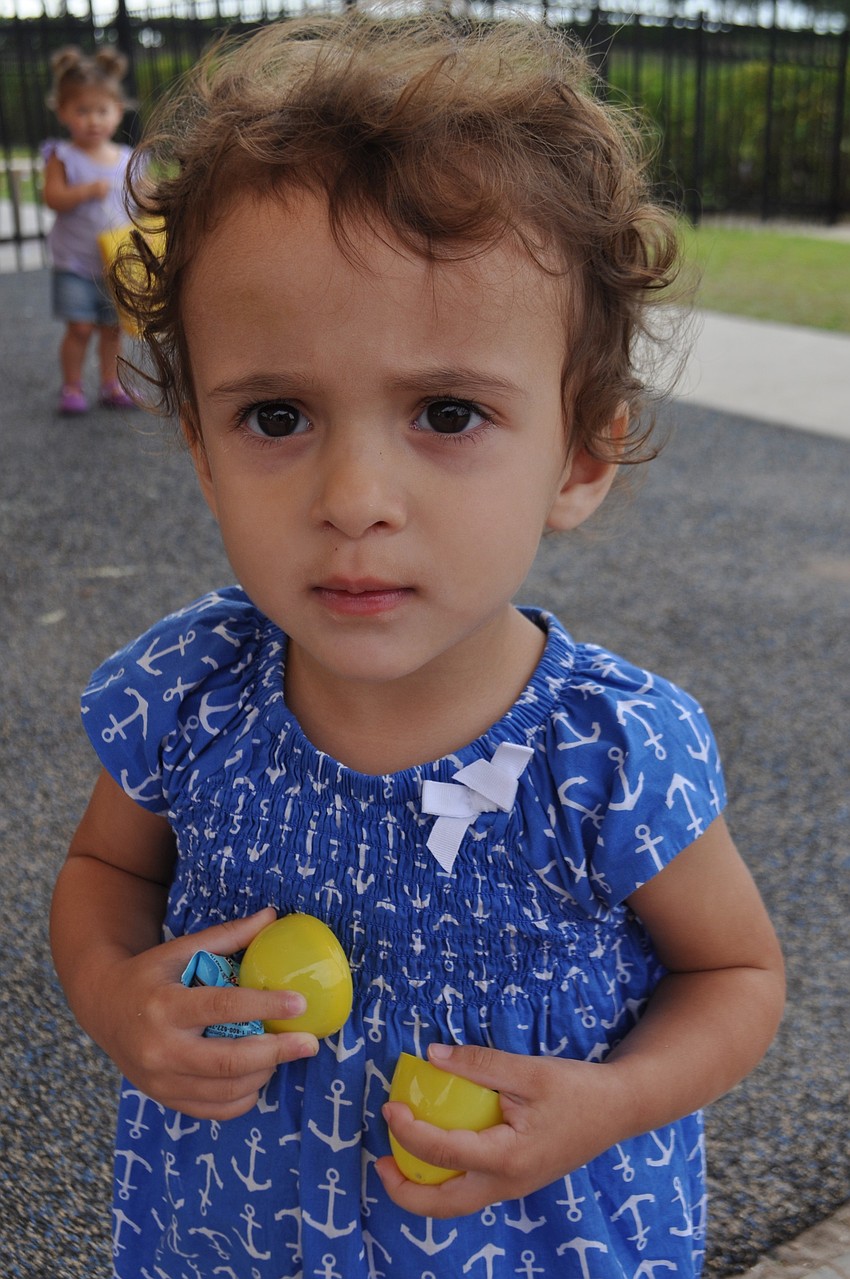 Mila Munoz gathers a handful of eggs.
