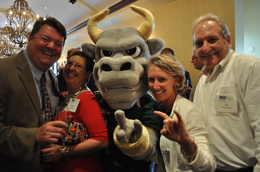 John Horne, owner of the Anna Maria Oyster Bar, with his wife, Amanda, and the USF mascot, Teresa Rawe and Bob Richardson