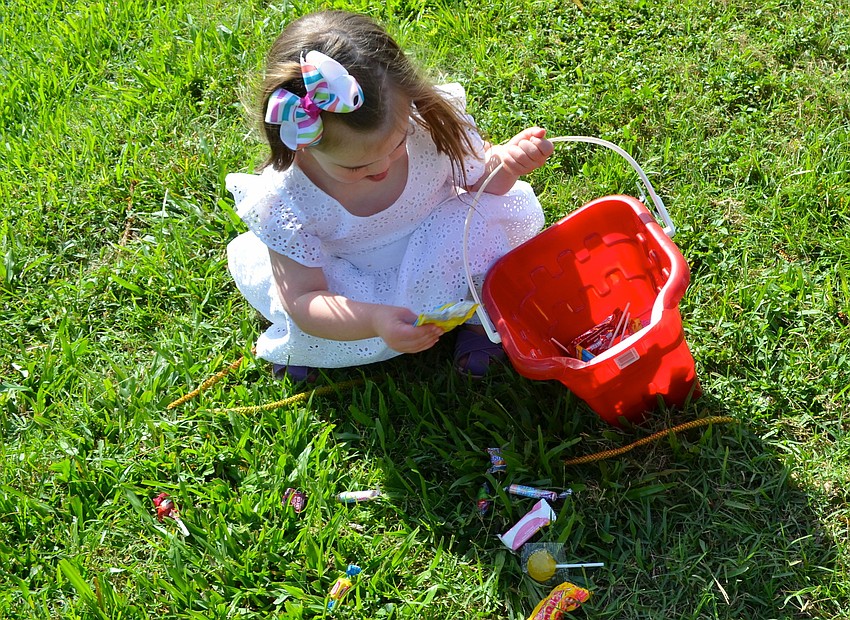 Elise Fetherston picks up candy during the Easter egg hunt.