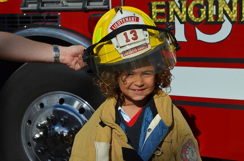 Balthazar Ciesar tries on a fire fighters suit.