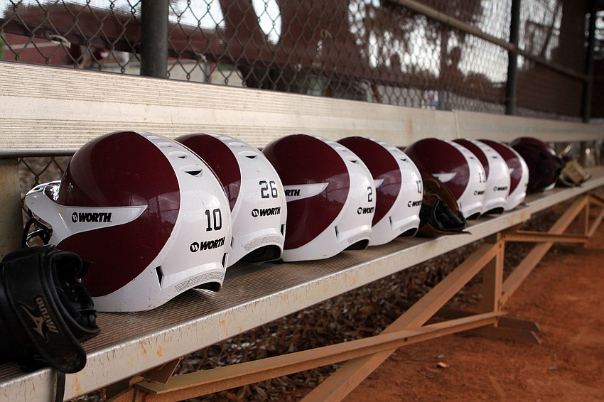 Riverviewâ€™s helmets all lined up on the bench inside Riverviewâ€™s dugout.