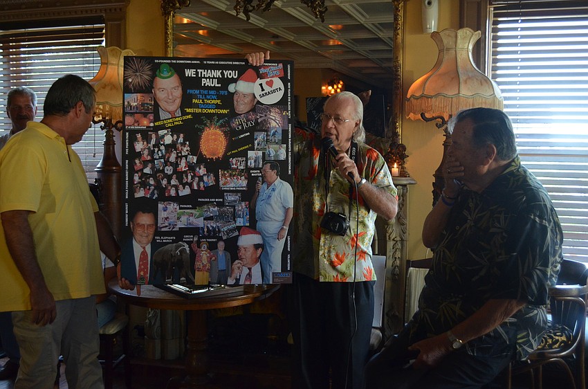 Don Adamec presents Paul Thorpe with a collage board of Thorpe through the years.