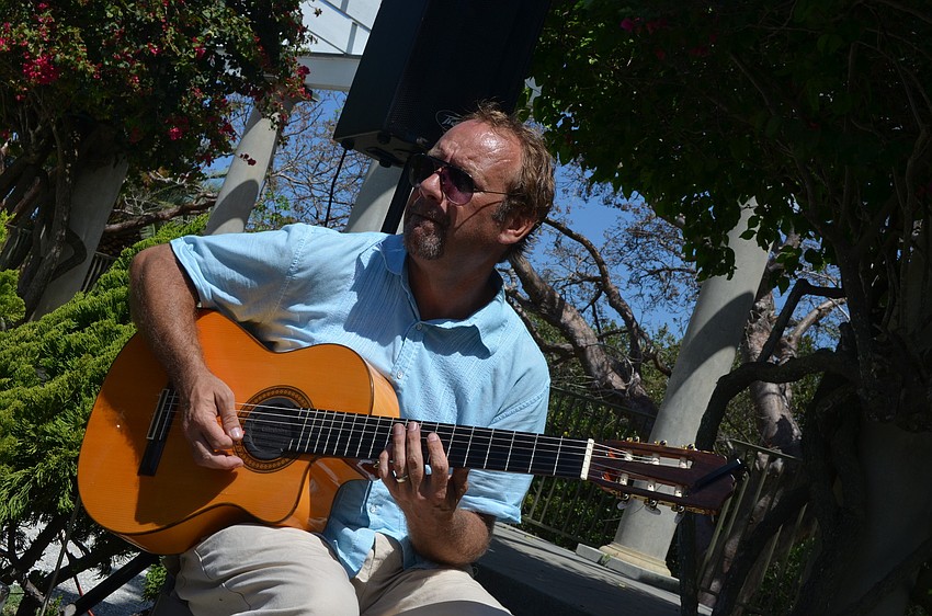 Bryan Spainhower plays Spanish guitar for community members.