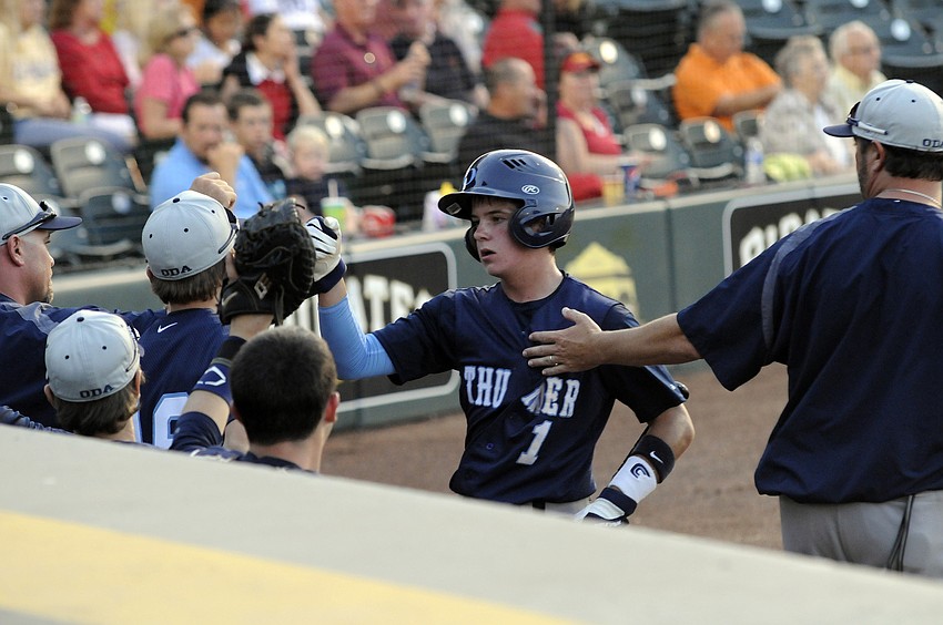 ODA sophomore Carson Jungers is congratulated after scoring a run in the top of the third inning.