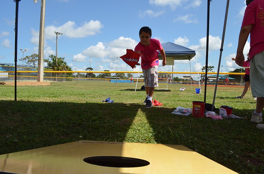 Maciej Tadla plays corn hole and runs the corn hole booth.