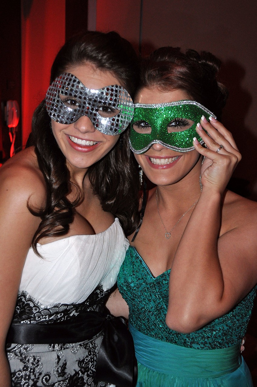 Arianna Dececco and Alex Oâ€™Keefe have fun trying on the masks set out on all the different tables.