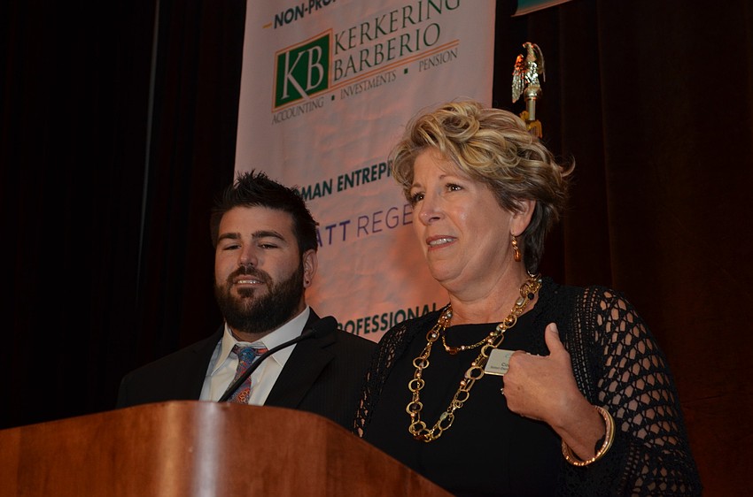 Coral Pleas of Cutting Loose Salon and her son Travis Scheuer express their gratitude after winning the Young Business of the Year Award.