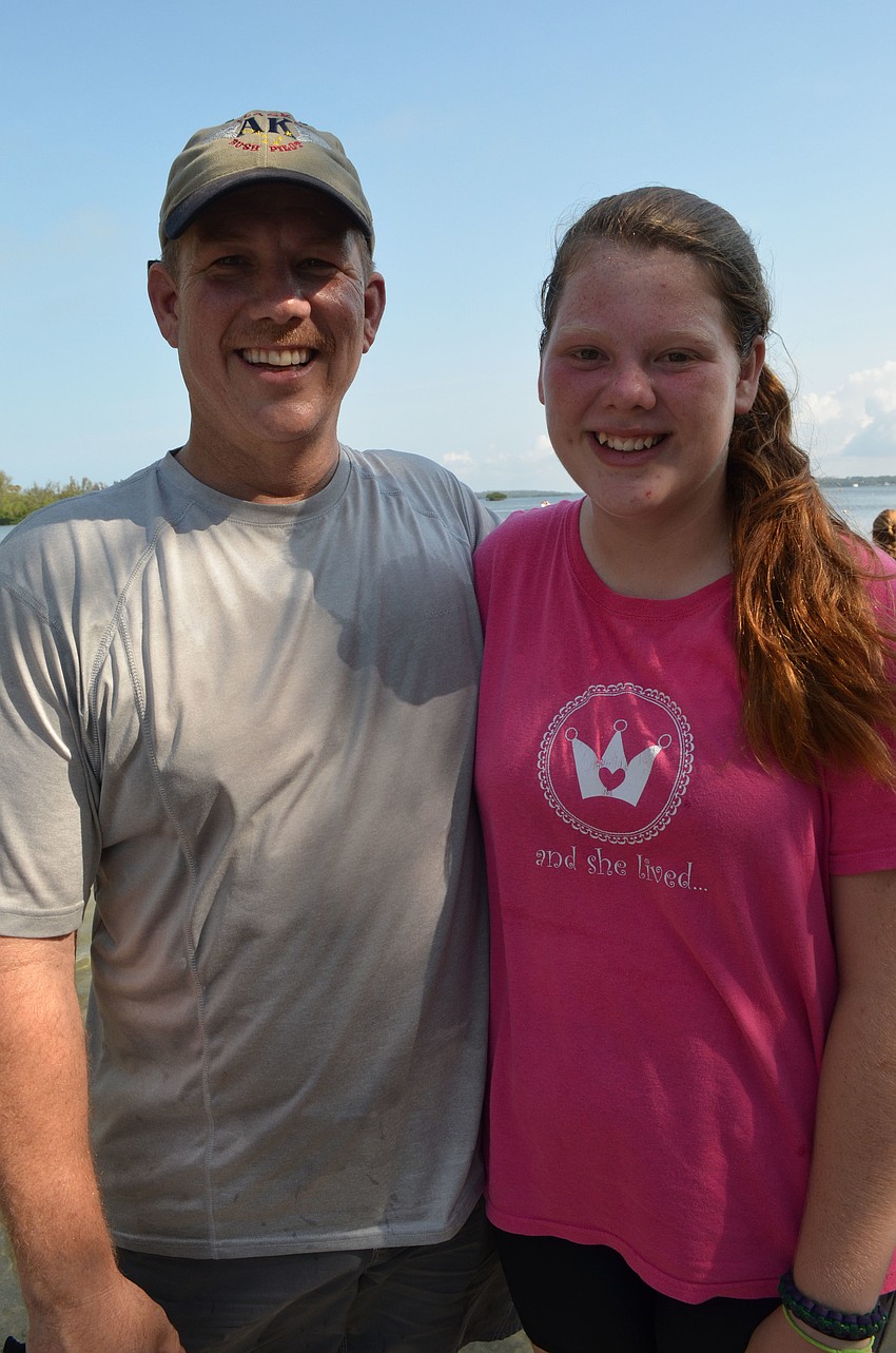 Mark Parisi gets out of the water with his daughter Marin.