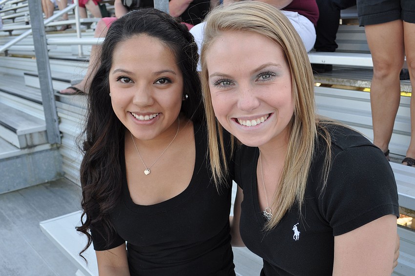 Outgoing seniors Michelle Tran and Cayton Chrisman, former cheerleaders, came to cheer on the new varsity cheerleading squad.