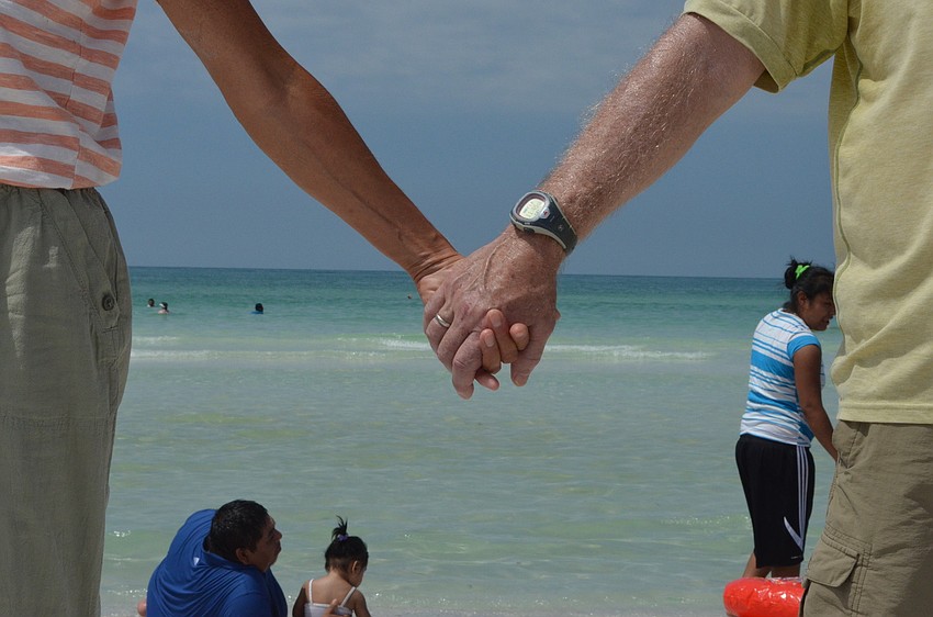 Forty-two community members joined hands across the shoreline at the public beach.