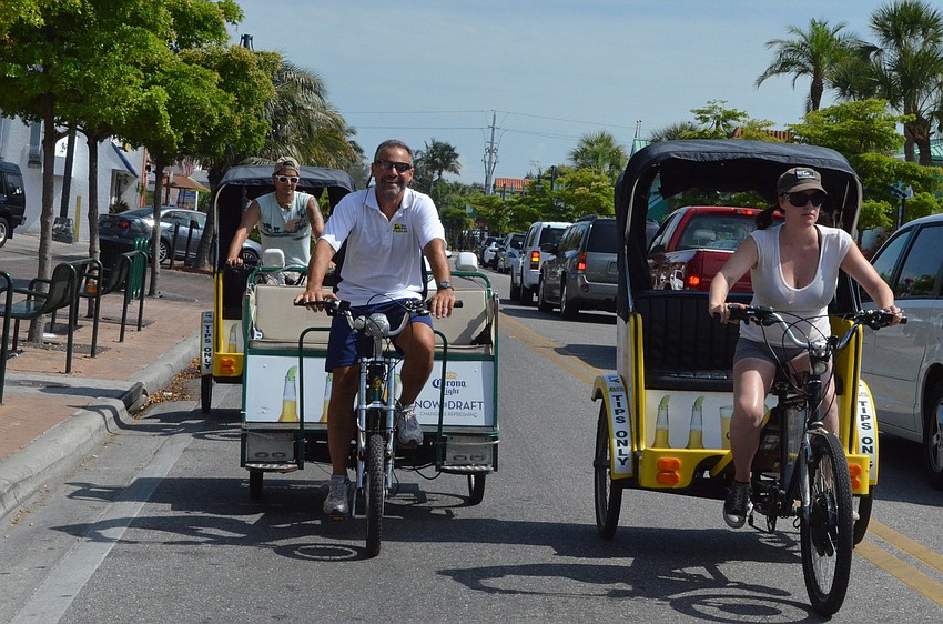 Ty Schott, Glen Cappetta and Courtney Kees of Sun Coast Pedicabs shuttled people to the beach to show another example of clean transportation.