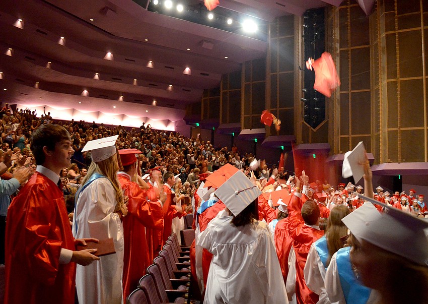 Seniors throw their caps in celebration.