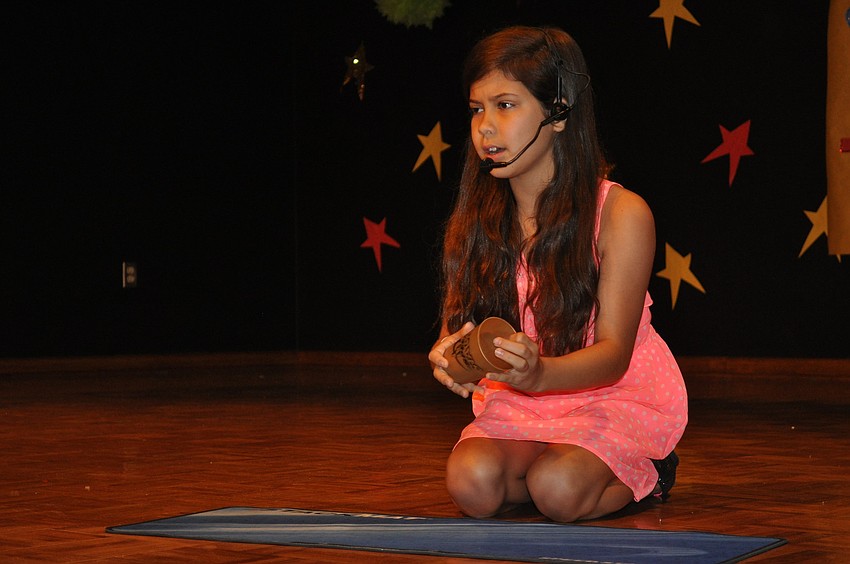 Emily Chance sang while doing tricks with a cup.