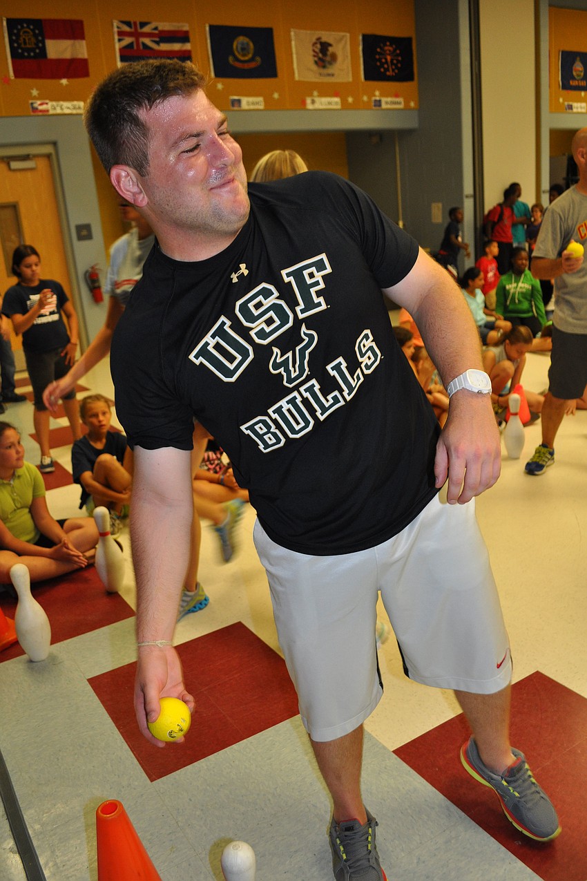 Teacher Mark Wojcicki shows off his aim, during a match-up against fifth-grade students.
