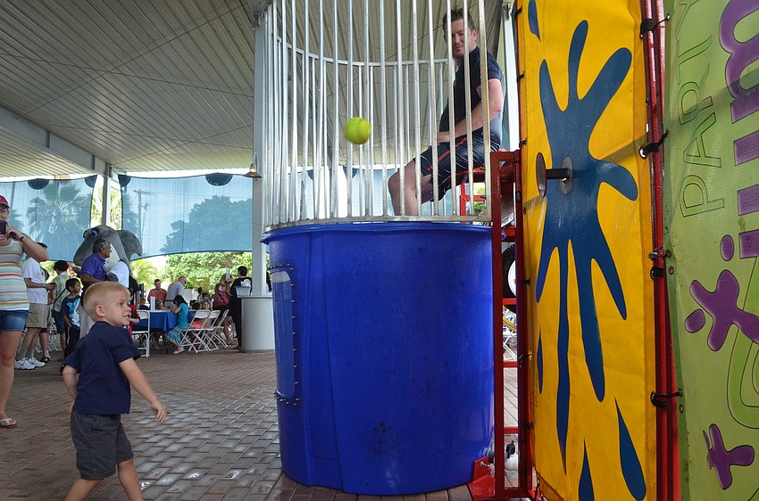 Davin Cumston, 4, throws a ball at the dunk tank.