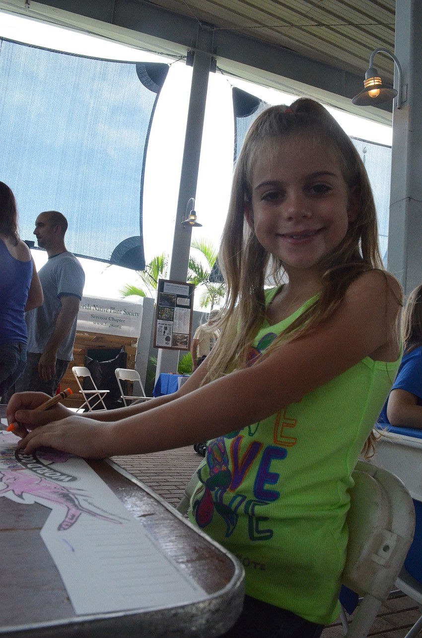 Amber Reynolds, 8, colors at the craft table.