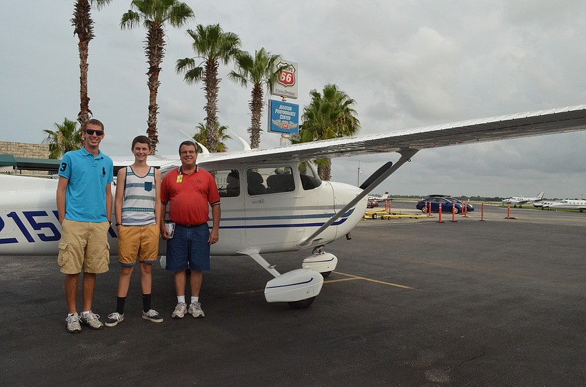 Nick Fenske and Eli Converse get ready to take off with Pilot Jeff Walston.