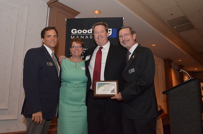 Bob Stanell of CS&L CPA's accepts the award for 2013 Outstanding Partner of the Year from Rick Hughes, Veronica Brandon Miller and Bob Rosinsky.