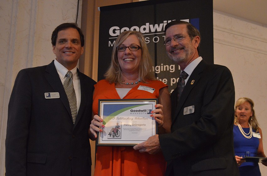 Rick Hughes and Bob Rosinsky present Penny DiGregorio with a volunteer award.