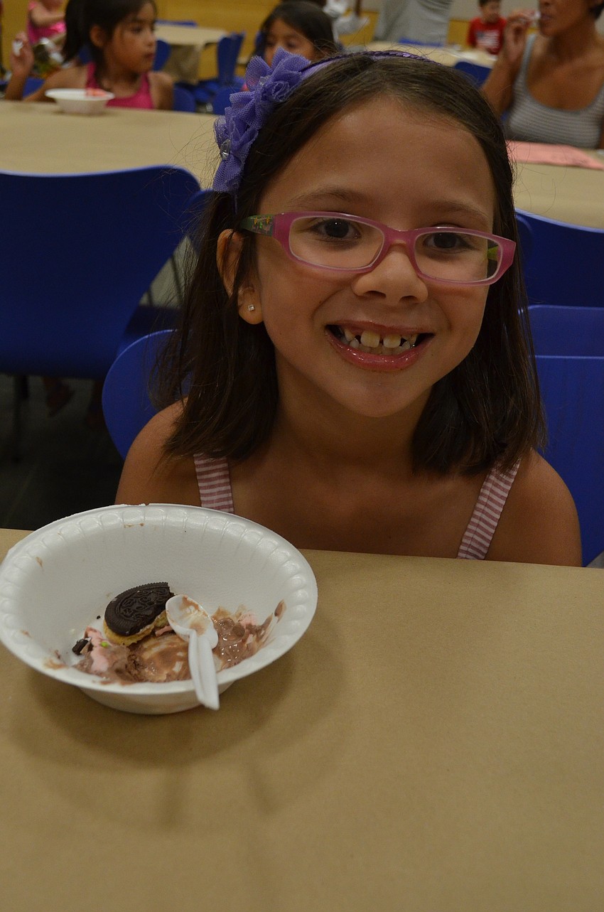 Daniella Mueller, 7, enjoys some chocolate ice cream.
