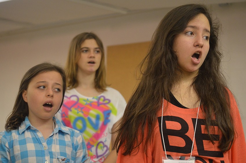 Emily Mulling, Shawn Meahan and Hunter Thorkelson sing along as Maestro Jesse Martin plays the piano.