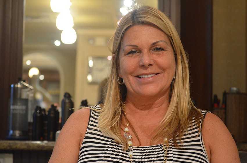 Laurel Oaks resident Robyn Collins gets ready to get her hair curled. She wants to know how to keep her hair curly in the summer humidity and heat.