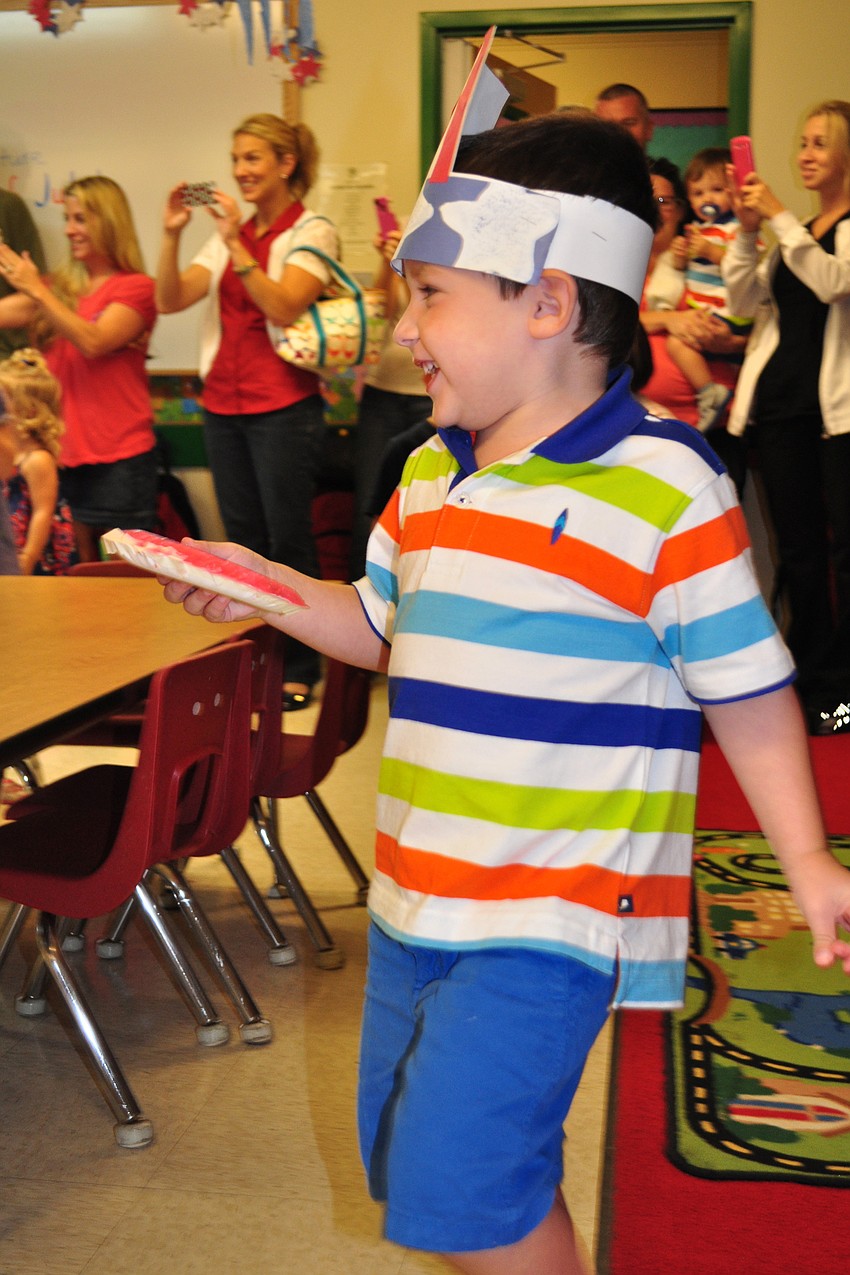 Beau Hirons, 3, canâ€™t stop smiling while he marches.
