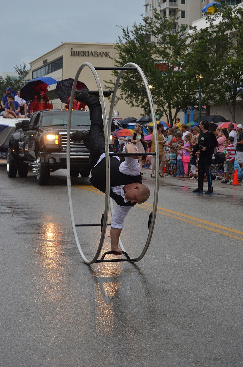 This man cart wheels in this metal circle down Main Street.