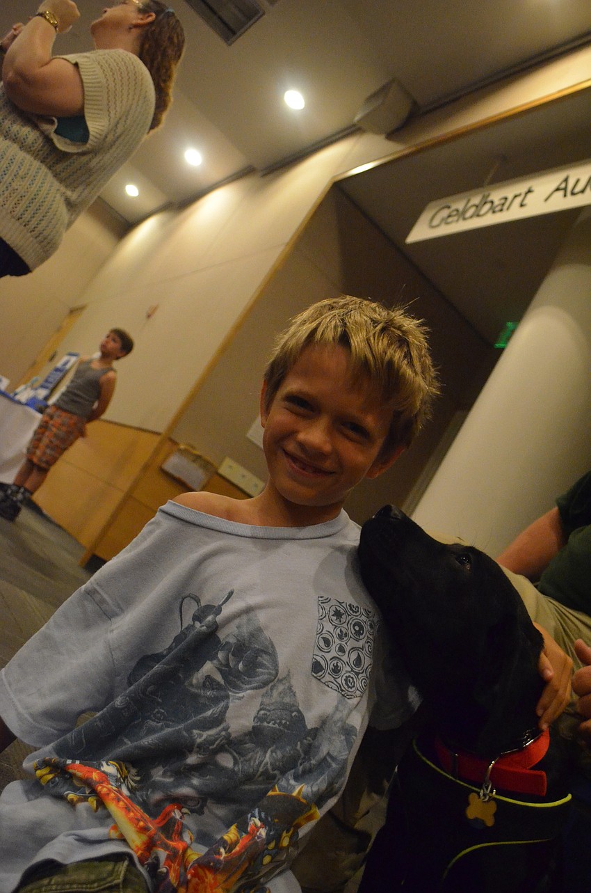 Graham Pobjoy, 9, gets a doggy kiss from 17-week old Kaleb.