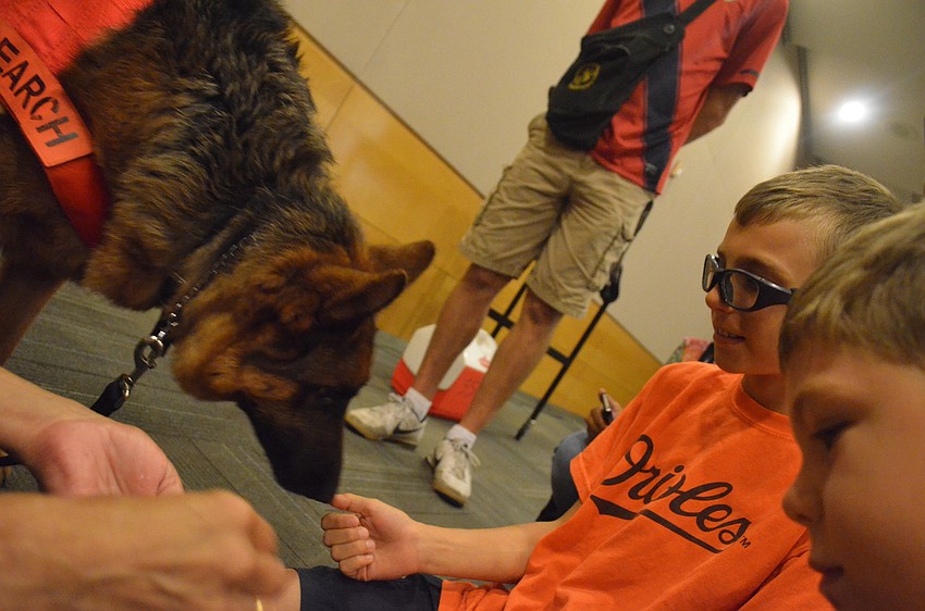 Zeke Williamson, 7, and his brother Sam, 11, feed German shepherd Ana.