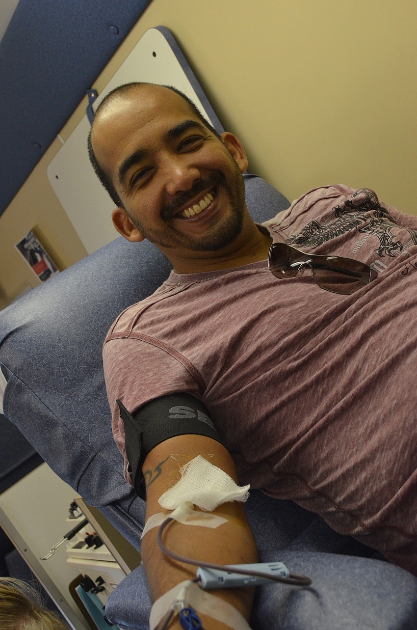 Enrique Pino donates blood for Badges to support his police officer friends.
