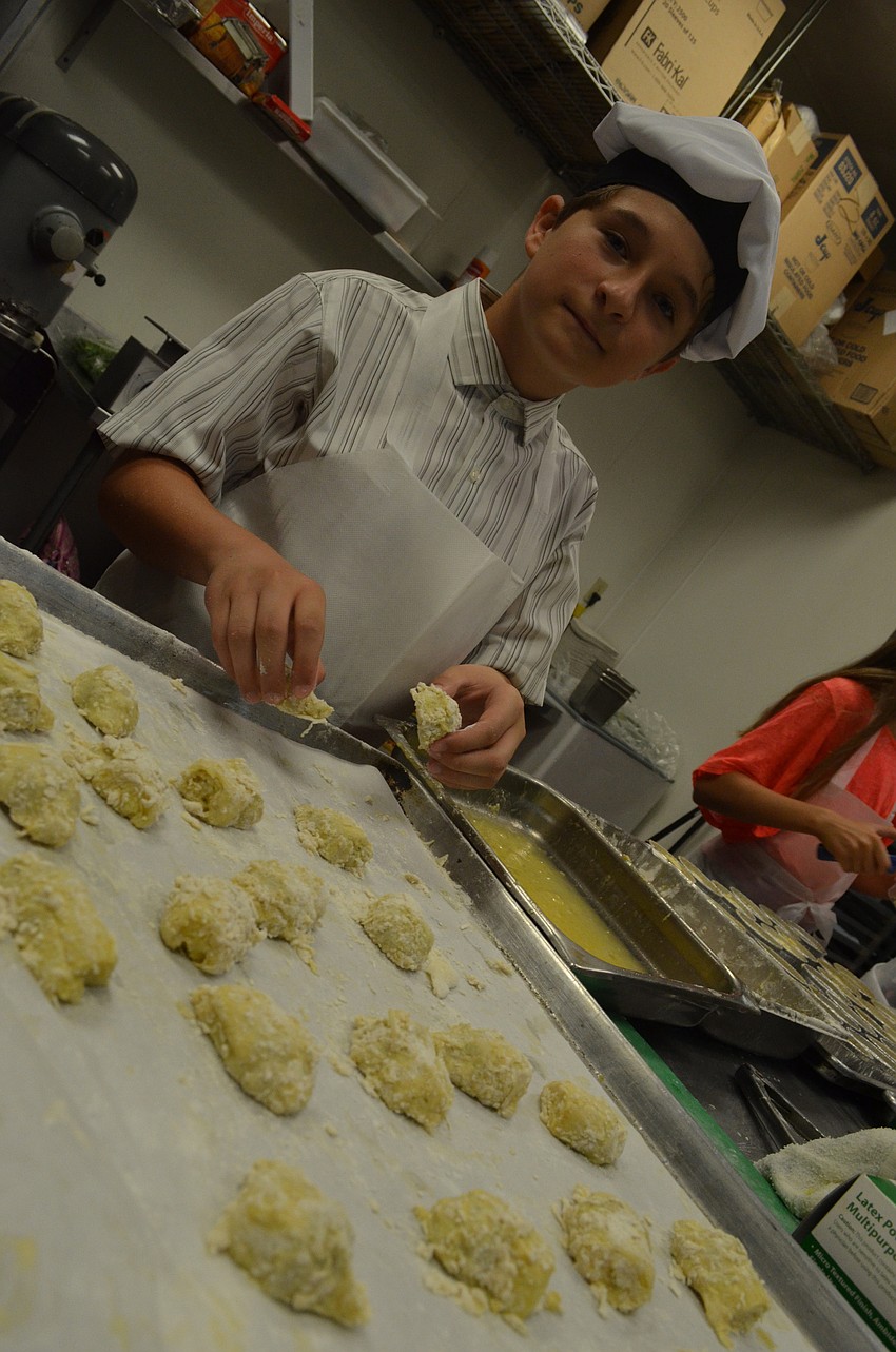 Nicolas Duverneuil, 13, batters artichokes before Max Aston fries them.