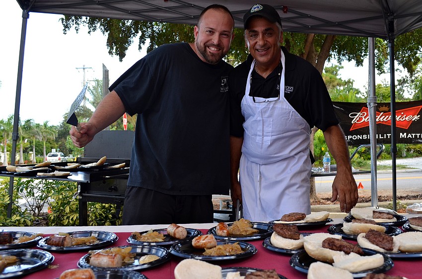 Adam Lawrence and Victor Petriella represent Mortonâ€™s meat department with brats and burgers.