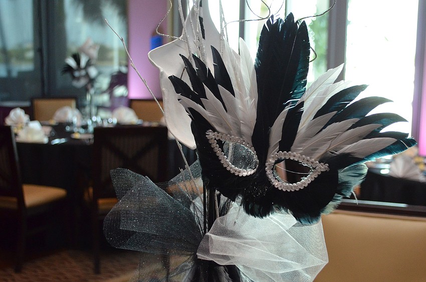Each table centerpiece was topped with a mask.