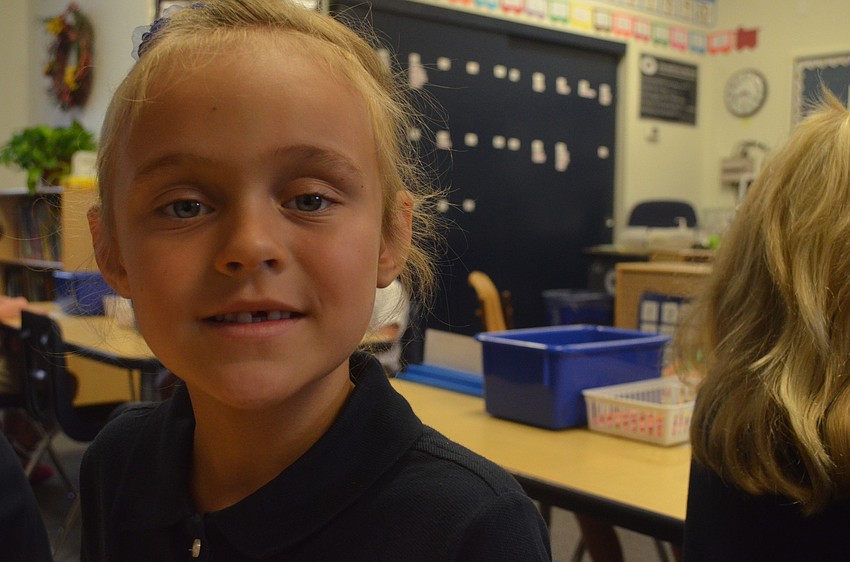 Mia P. settles in her seat for the first day of kindergarten.