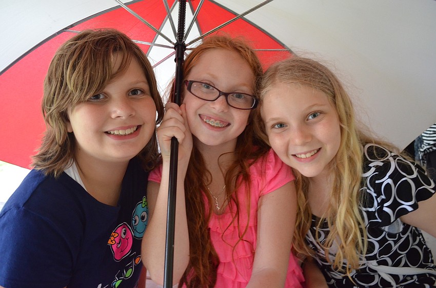 Emma Hershorin, 10, Marielle Newmark, 11, and Alexa VanSueh, 11, chat during the celebration.