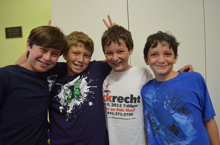 Jake Frank, 10, Justin Elliott, 10, Jacob Bloom, 10 and his brother Alex, 8, catch up after being away for the summer.